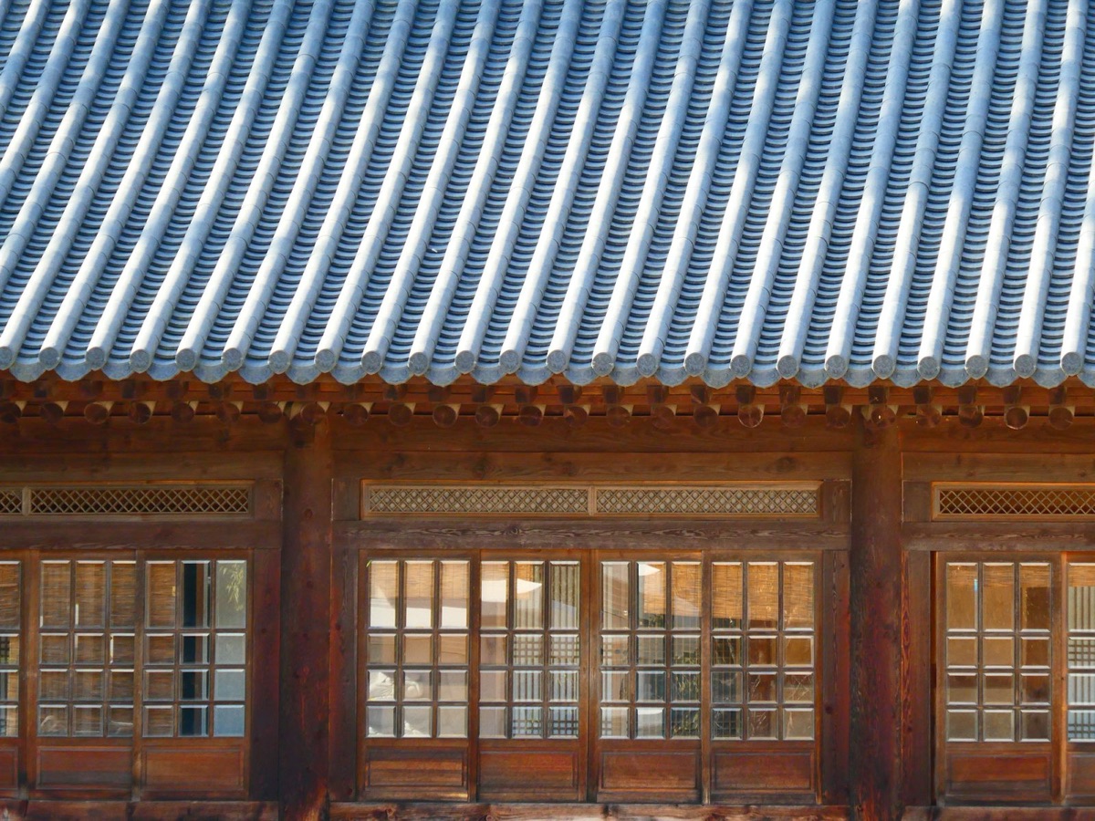 Tiled eaves and lattice window in warm light