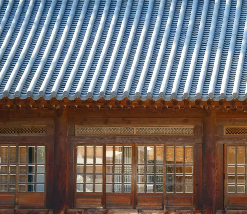 Tiled eaves and lattice window in warm light
